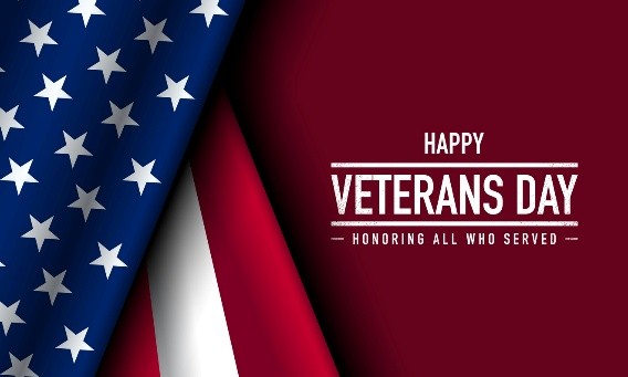 A group of people saluting in front of a flagDescription automatically generated